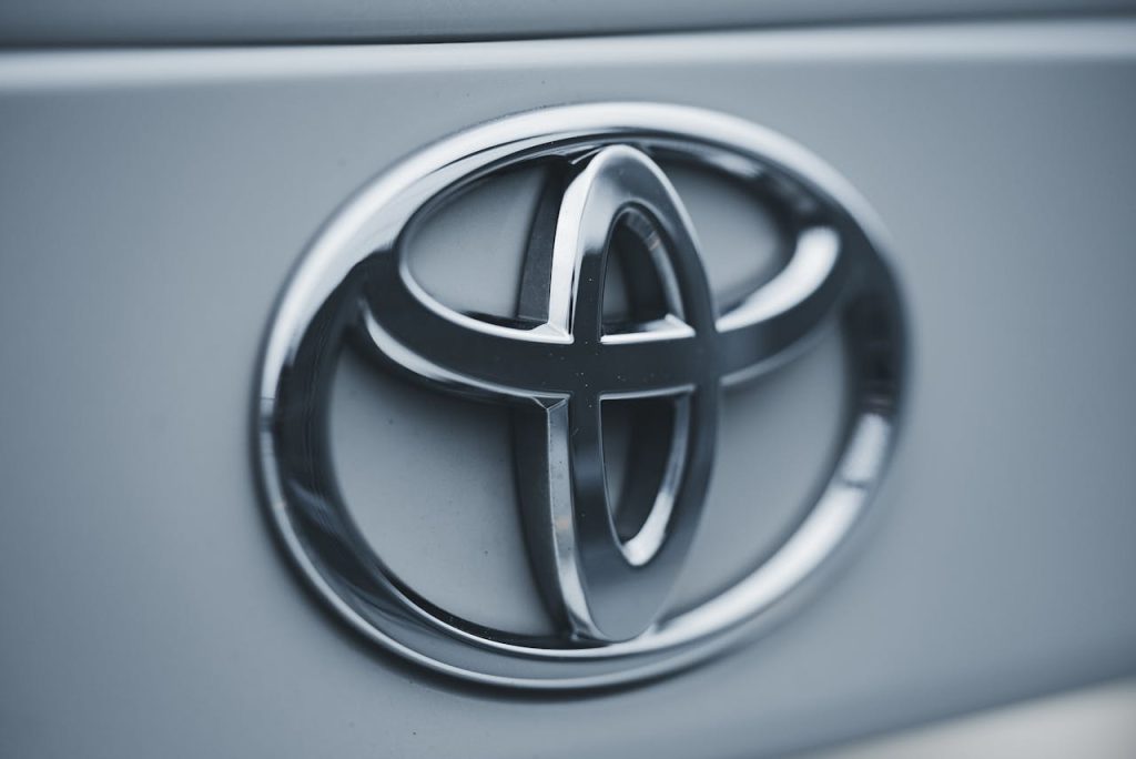 Detailed image of a shiny silver Toyota emblem on a vehicles surface.